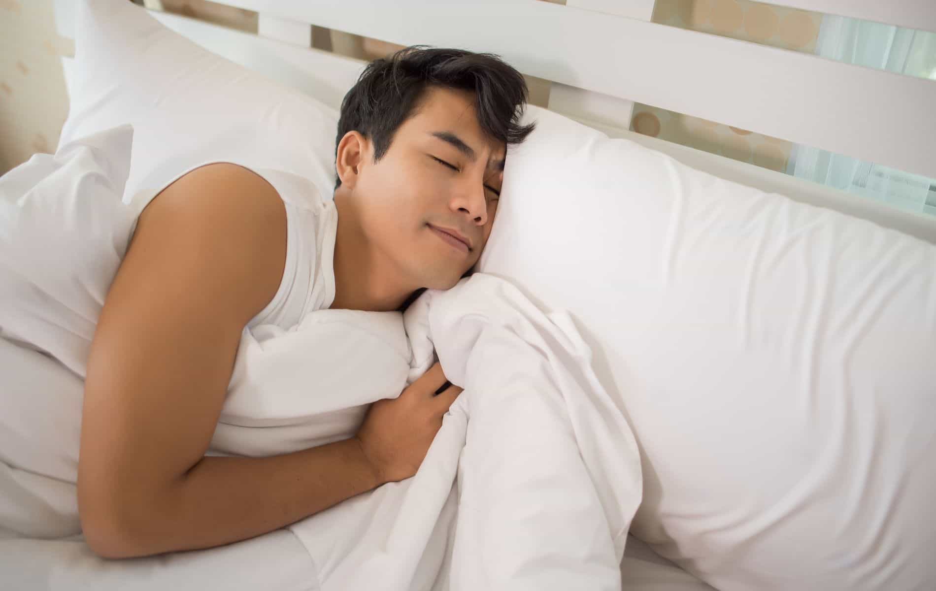 a man comfortably sleeps on the bed