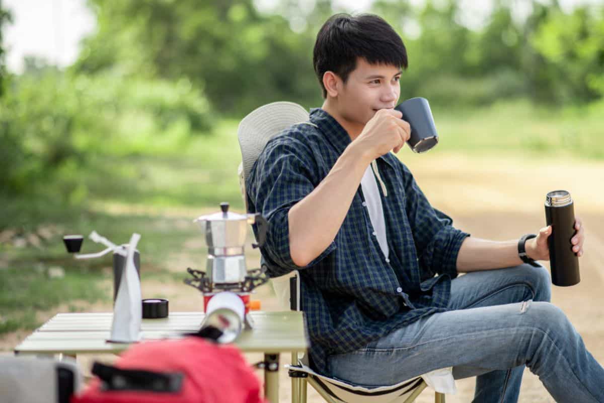 man enjoys a cup on hand