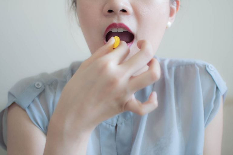 girl taking strepsils
