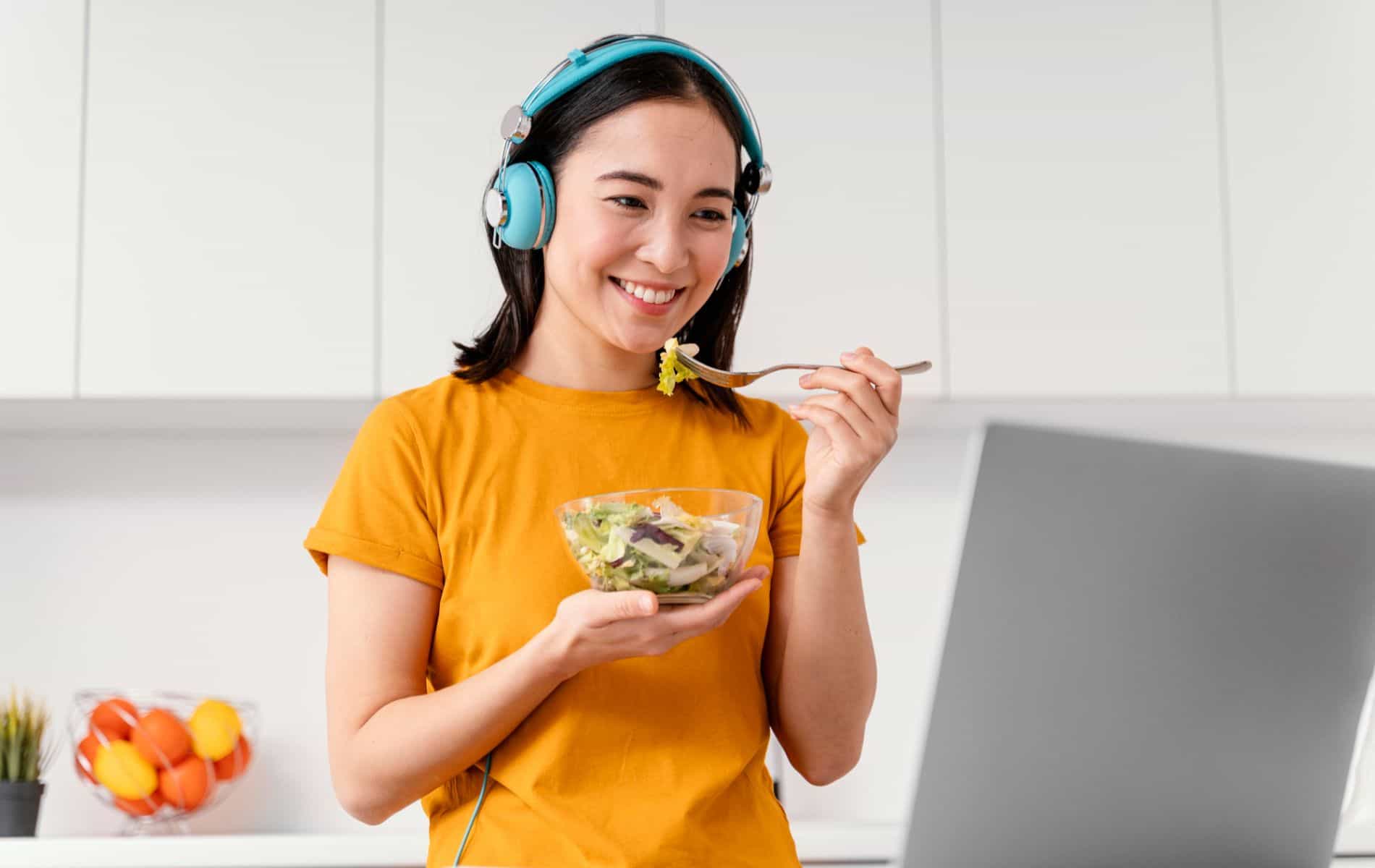 lady happily eats a bowl of salad